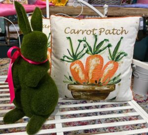 moss shaped bunny rabbit next to pillow that says 'carrot patch'