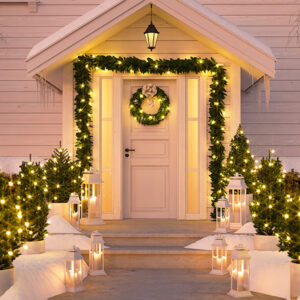 shrubs in front of home with christmas lights
