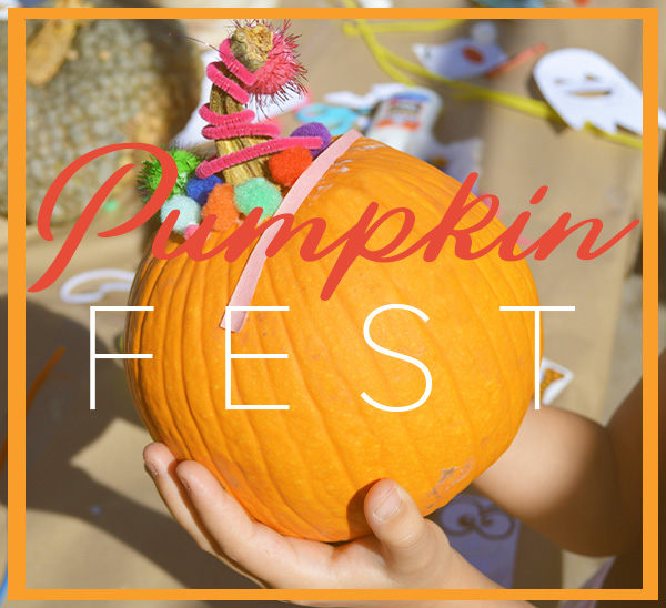 child holding decorated pumpkins with "Pumpkin Fest verbiage"