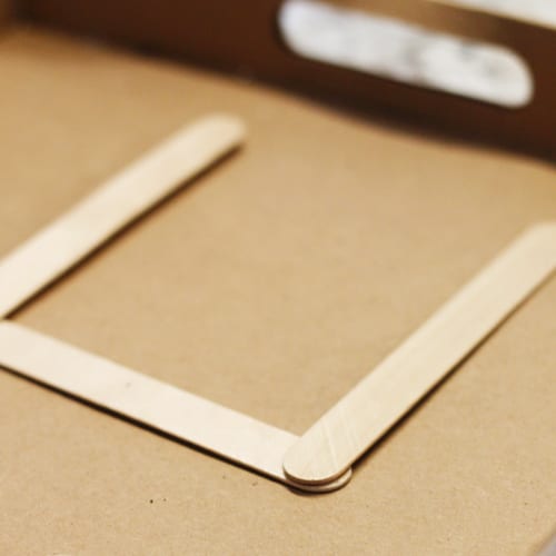 glue popsicle sticks into a U