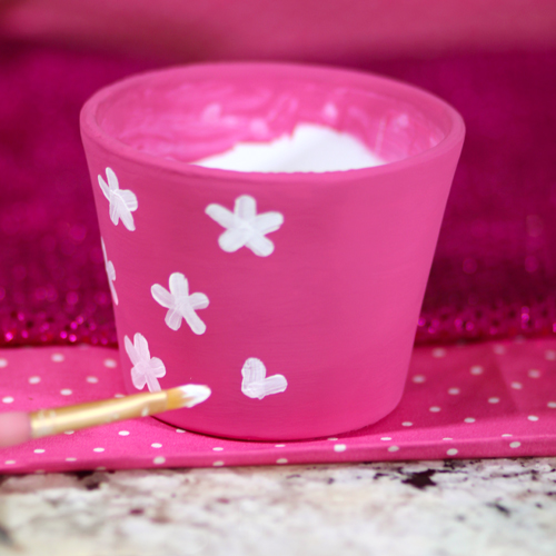 painting flowers on terra cotta pottery