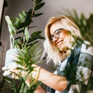 woman holding indoor plant