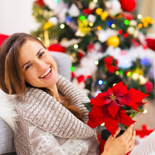 girl holding poinsettia