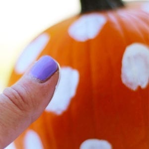 thumbprints with paint on pumpkin
