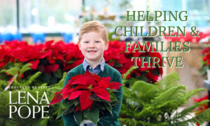 child holding poinsettia